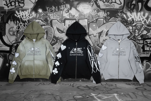 Three Lone Solitaire hoodies - Matcha, Black Monochrome, and Light Gray Monochrome with corrected sleeve details - on black and white graffiti background